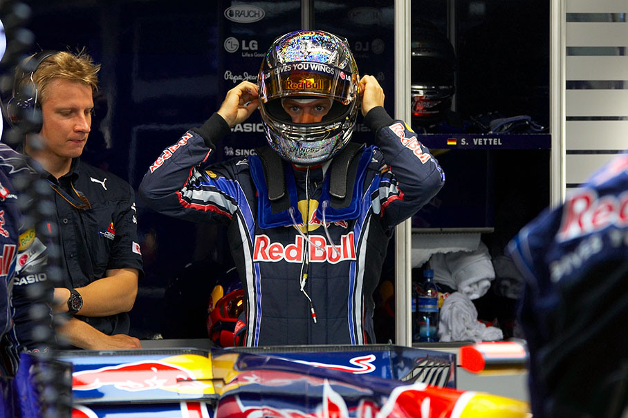 Sebastian Vettel puts his helmet on in Red Bull Racing pits