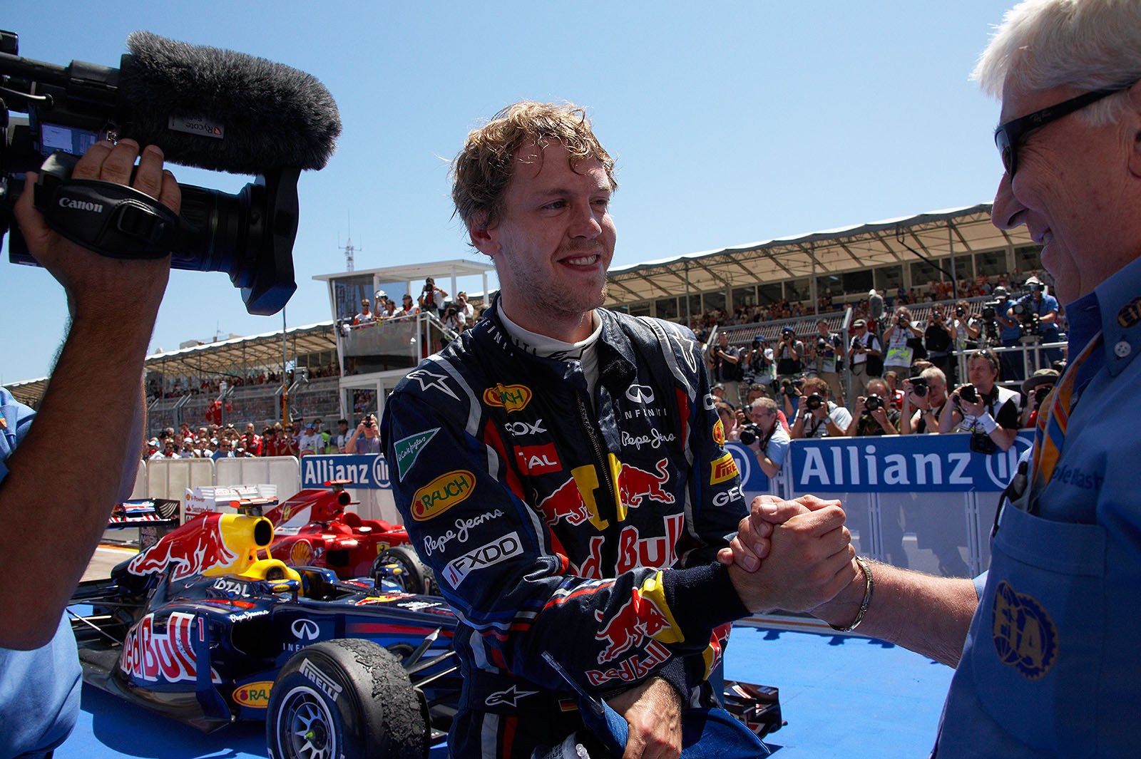 Race winner Sebastian Vettel receives congrats from FIA observer Herbie Blash in parc ferme
