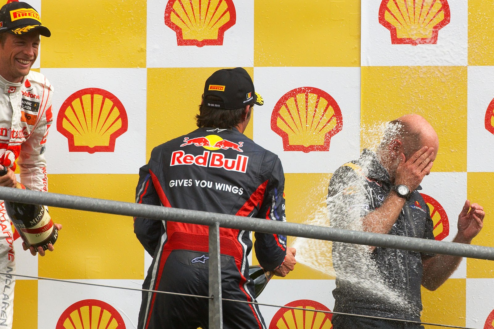 Webber's fast champagne shower for Red Bull Racing's technical director Adrian Newey after the Belgian Grand Prix 2011