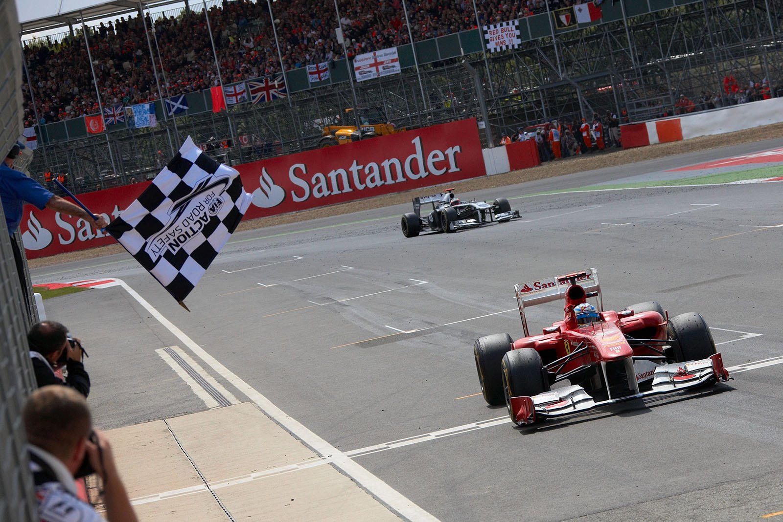 Fernando Alonso takes the chequered flag and wins for Ferrari 60 years after Gonzalez did in Silverstone