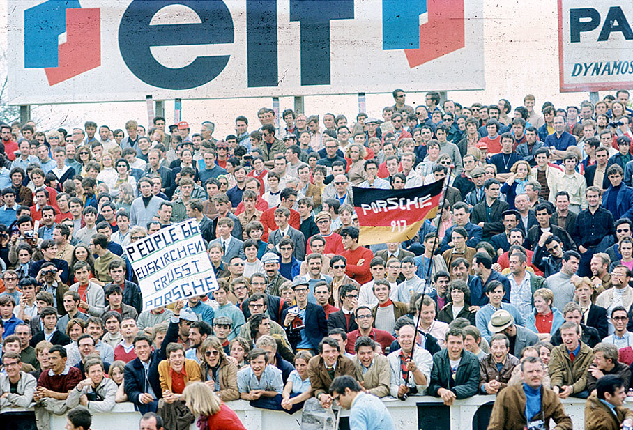 Porsche fans wave banners on Le Mans main grandstand