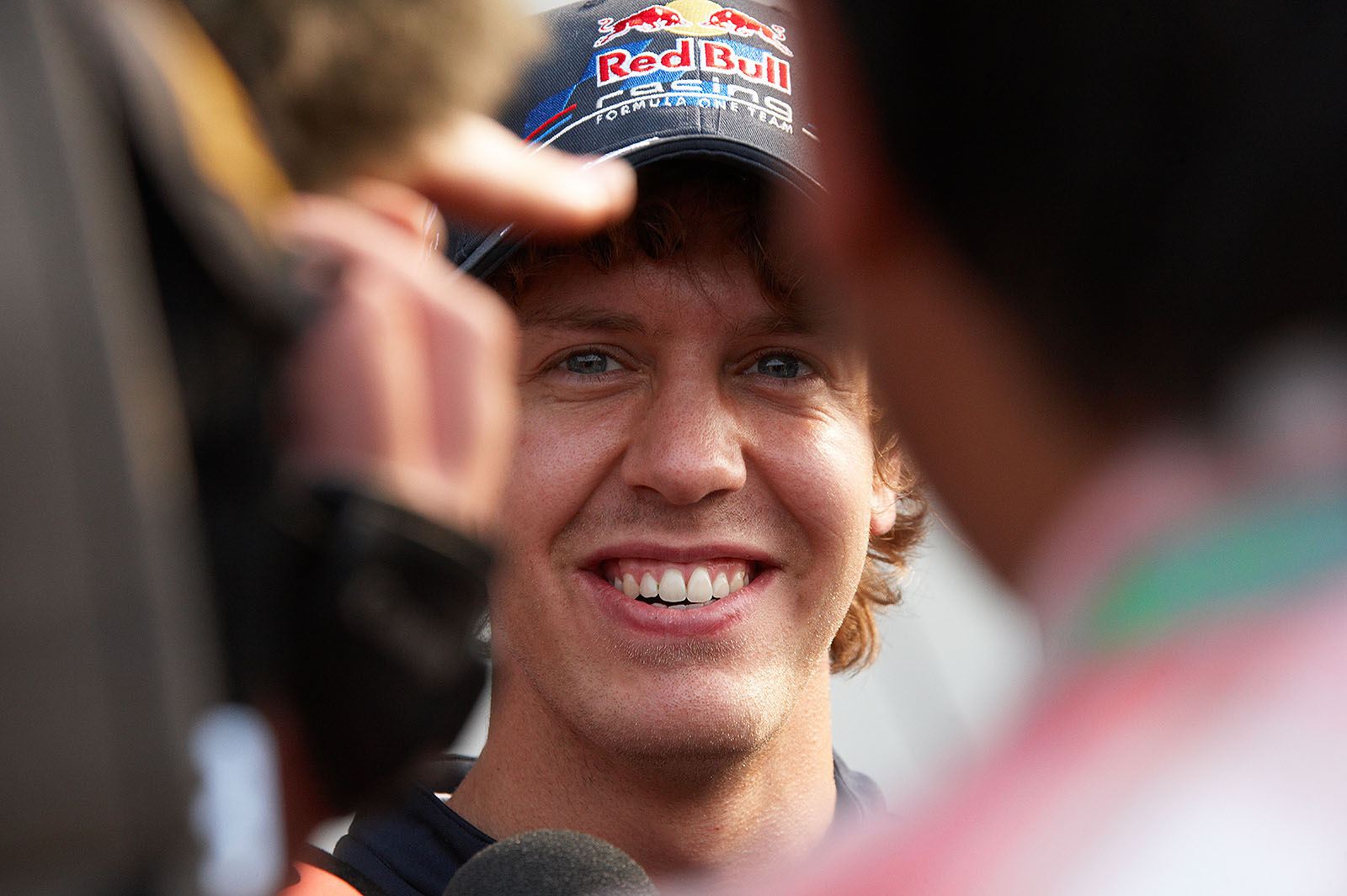 A confident looking Sebastian Vettel is interrogated