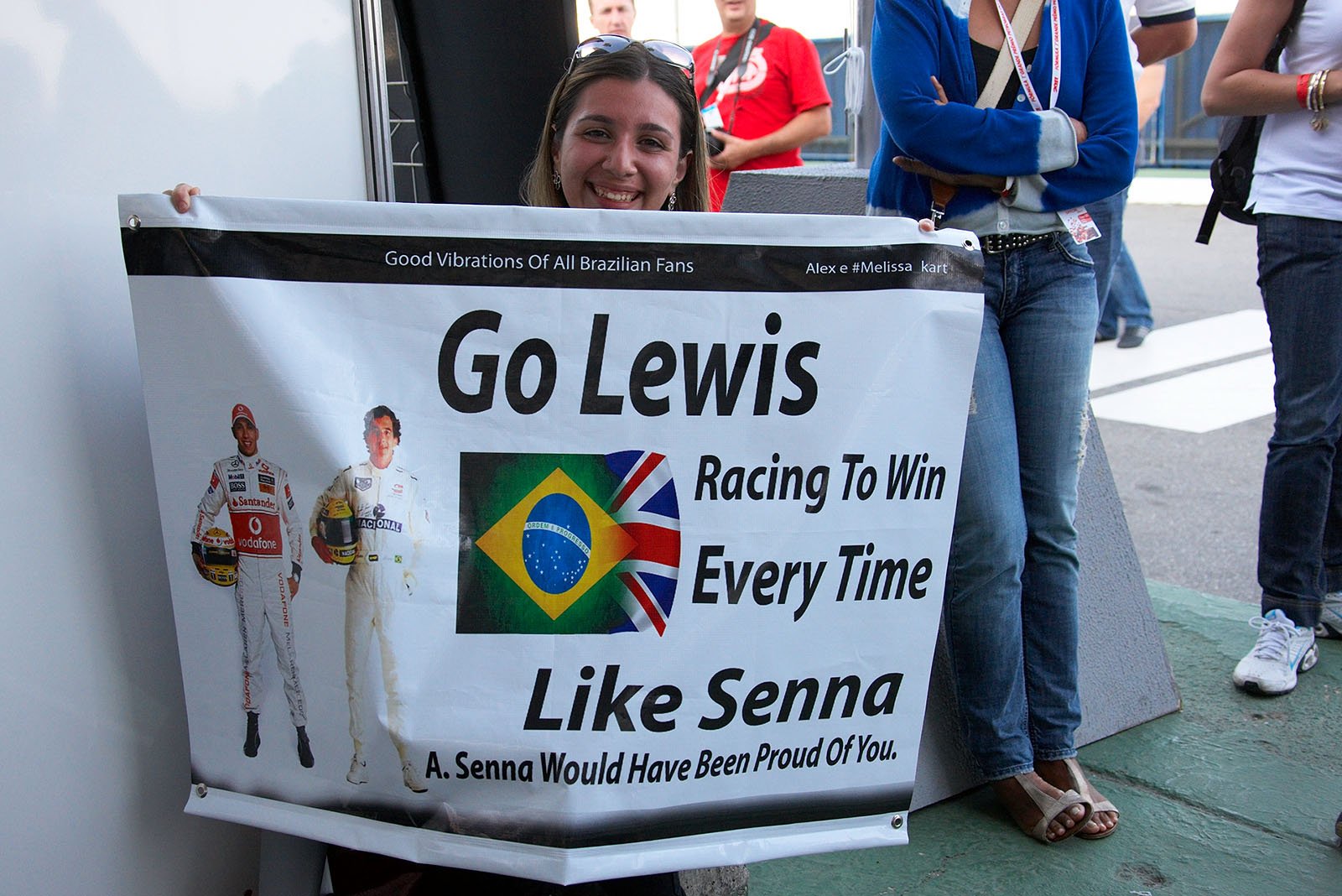 A Brazilian fan cheers for Hamilton with a Senna-related banner