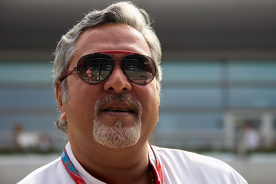 Force India team principal Vijay Mallya (note Rainer and Martin in the suglasses' reflection:)