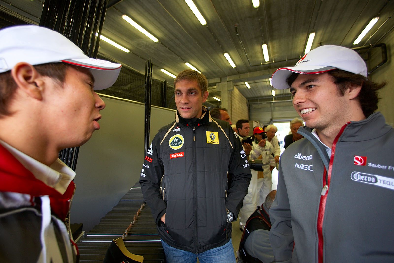 Race drivers chat before the parade on Sunday - Vitaly Petrov and Sergio Perez listen to Kamui Kobayashi