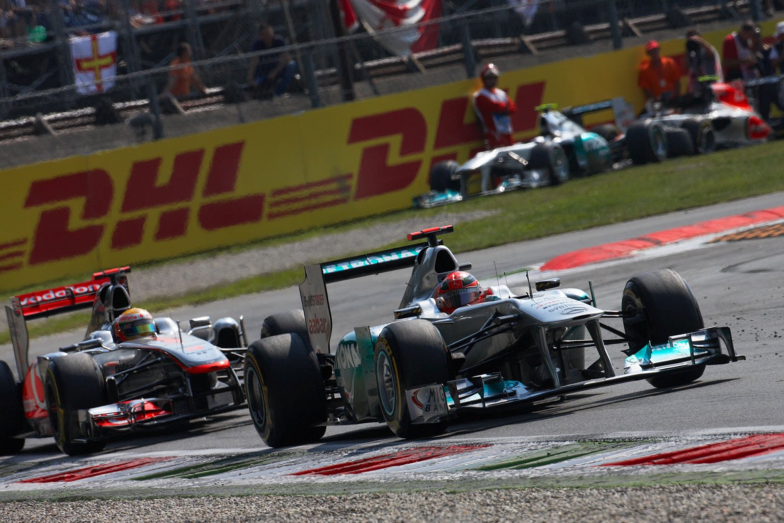 Michael Schumacher, Mercedes GP, sticks in front of the McLaren's Hamilton