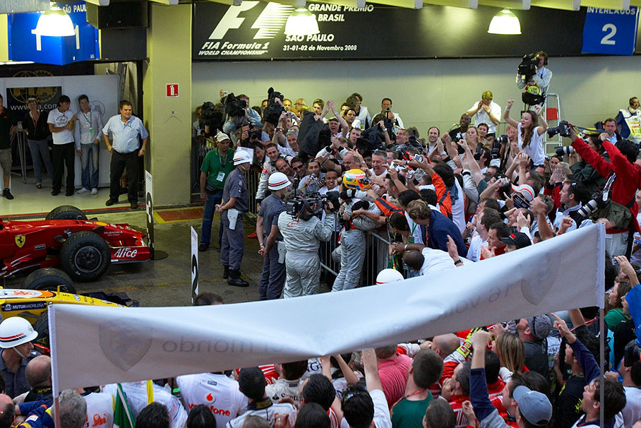 The new born Formula One World Champion 2008 Lewis Hamilton celebrates with family and team members at parc ferme fence