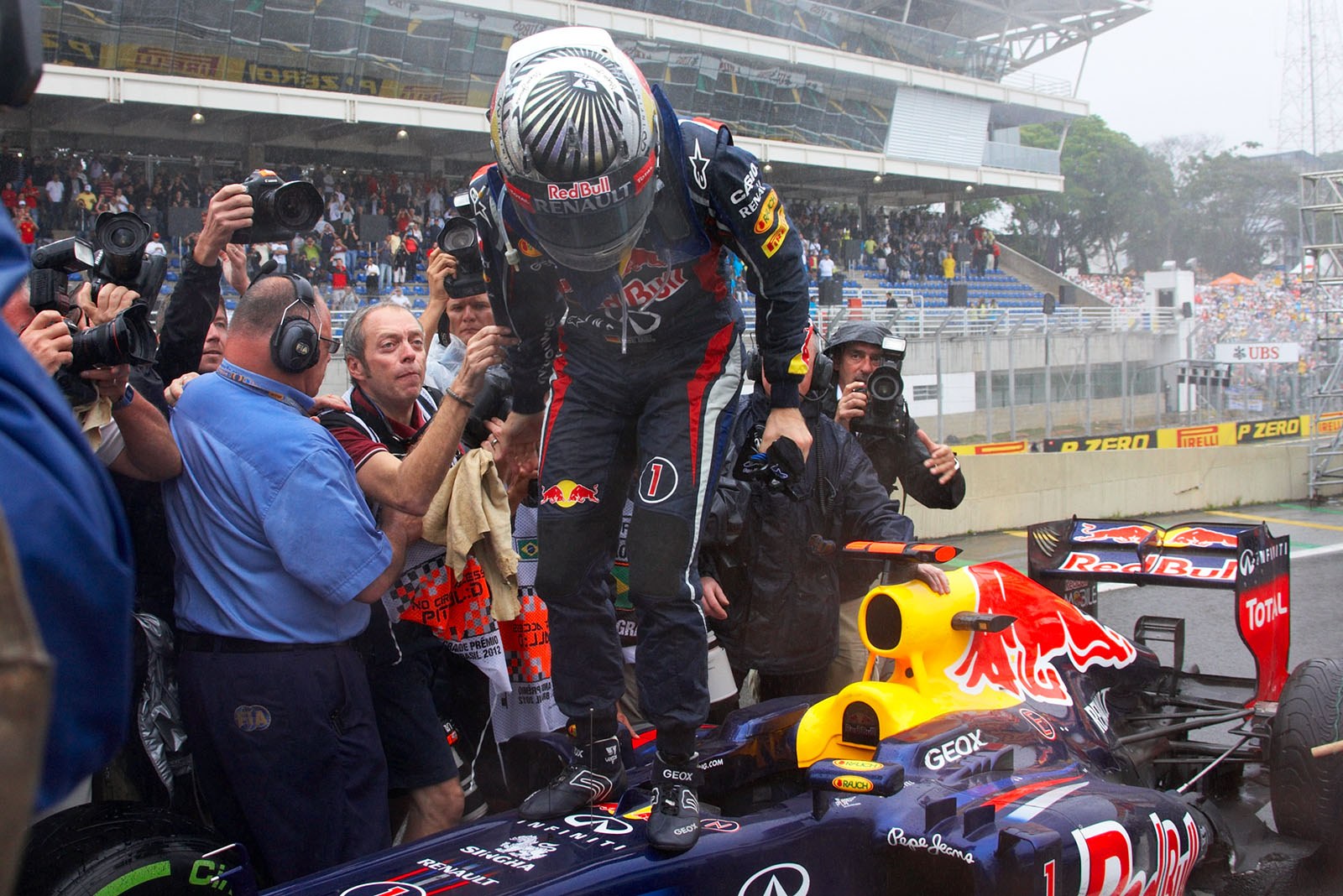 Sebastian Vettel, Red Bull Racing, stands on his race car in parc ferme as sixth placed and becomes the youngest triple F1 World Champion ever!