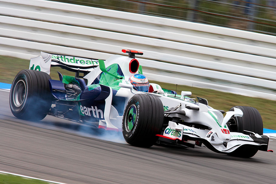 Jenson Button brakes at the hairpin